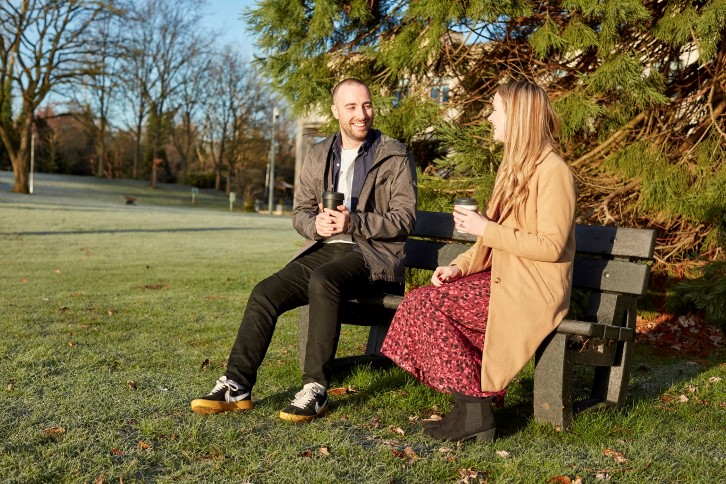 Colleagues having a conversation on a bench