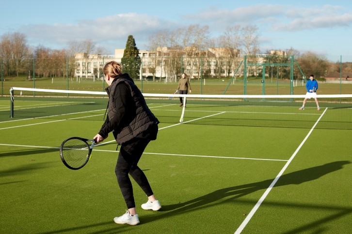 Colleagues playing tennis