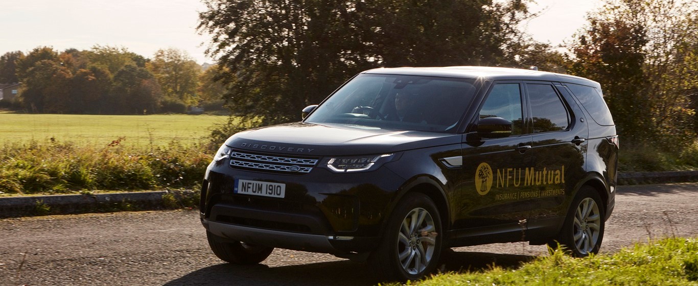 Black Range Rover Discovery with NFU Mutual yellow branding on the side