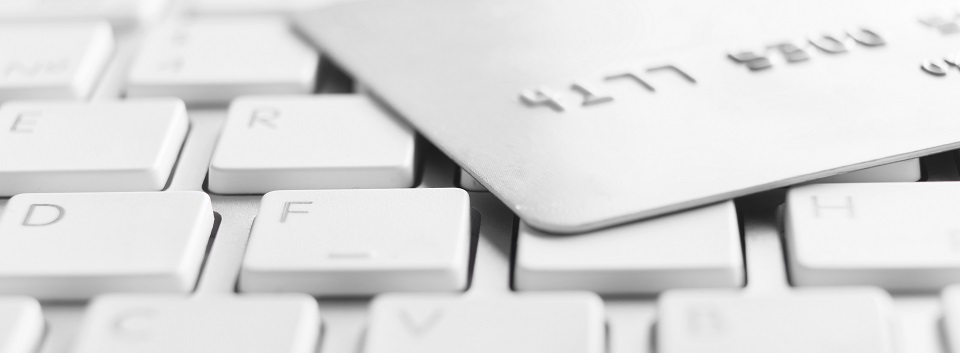 A close-up of a credit card resting on a computer keyboard.