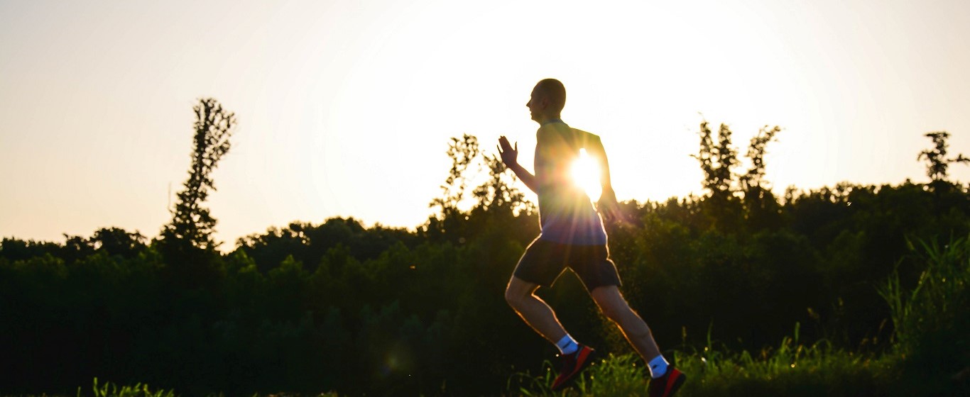 Person running outdoors at sunrise