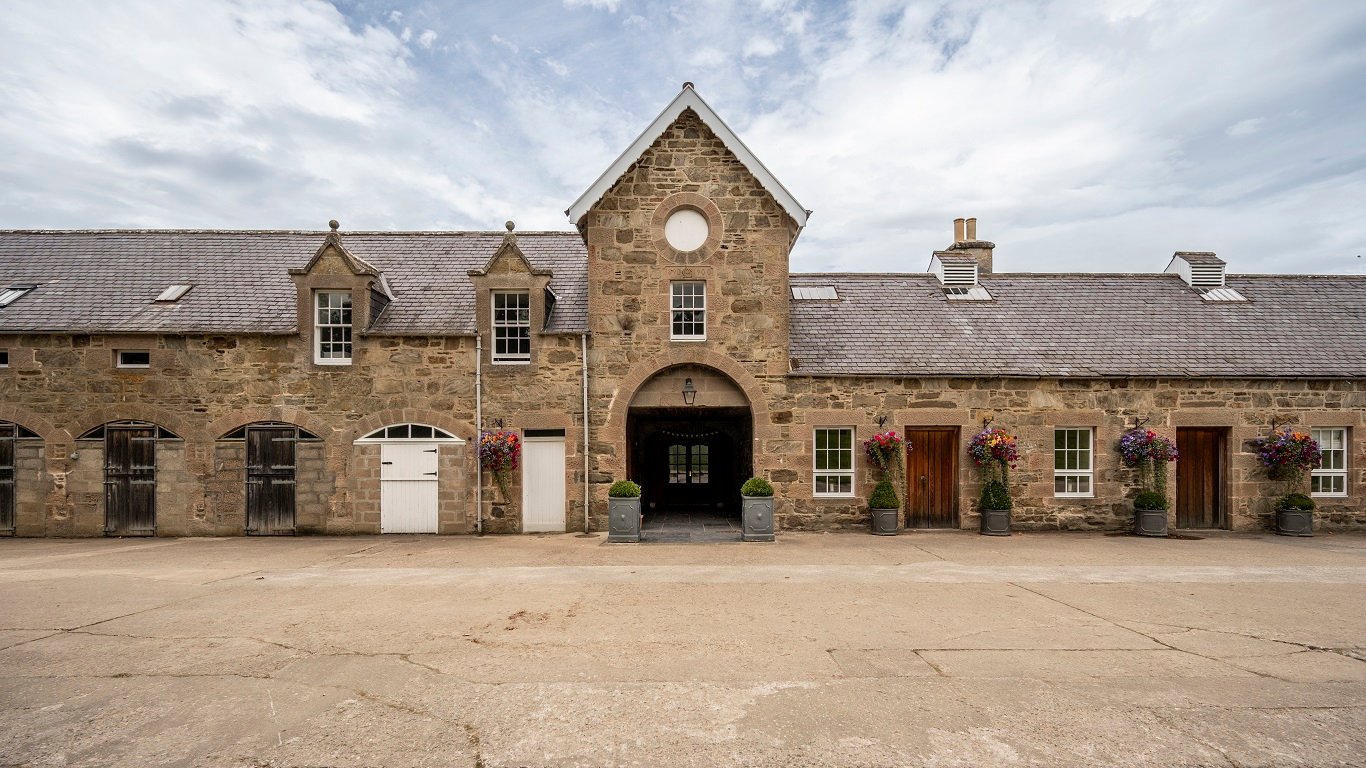Stone courtyard building with arched entrance